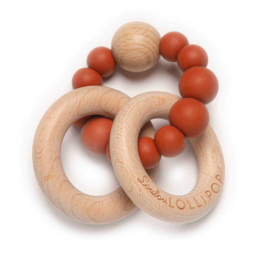 Silicone and wood teether by Lou Lou Lollipop in rust colour at Bonjour Baby Baskets