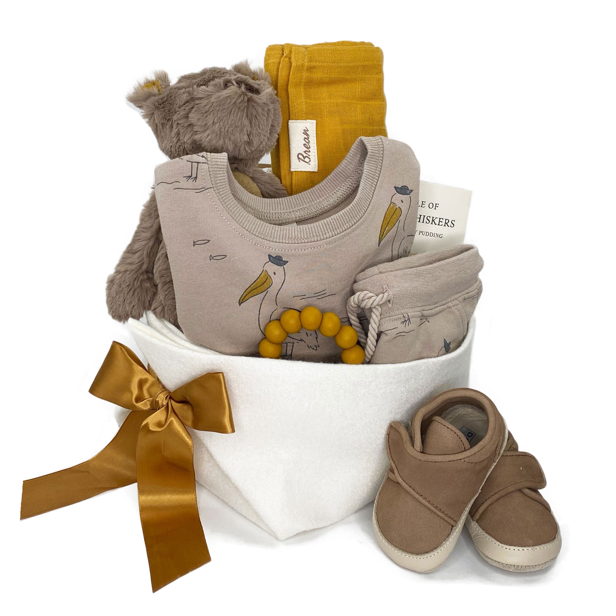 Trendy neutral baby gift basket featuring pelicans print sweatshirt and pants by Rylee and Cru, leather shoes by Donsje and toys for the perfect baby gift 