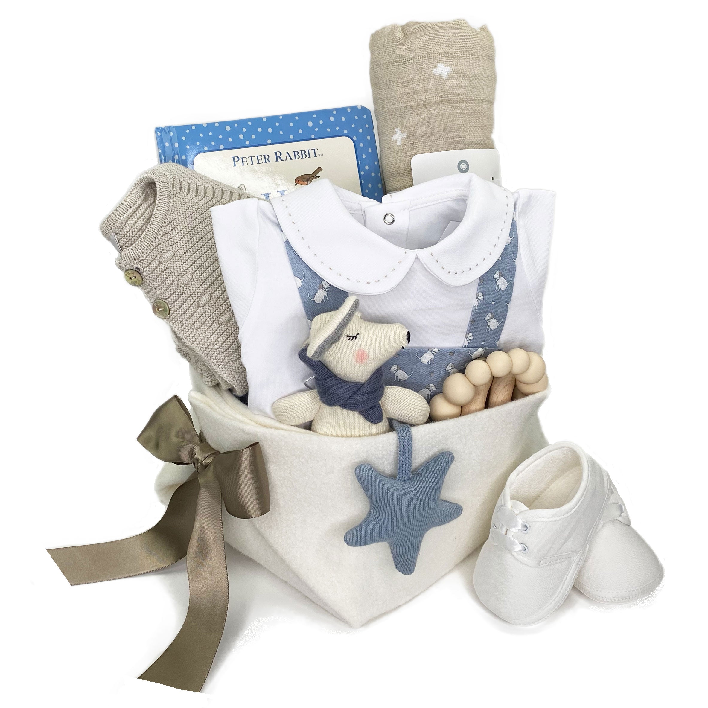 Luxury Baby Boy Gift Basket featuring Paz Rodriguez summer romper with doggies print, onesie with embroidery, knitted sweater and  unique curated baby gifts.